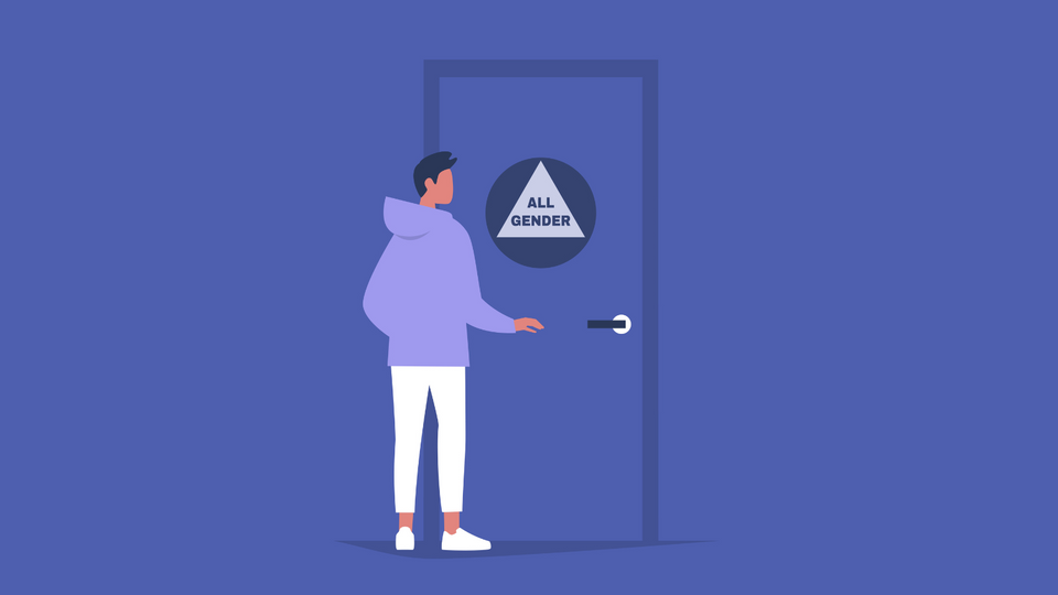 A person with short hair wearing an oversized purple hoodie opens the door to an all gender bathroom.